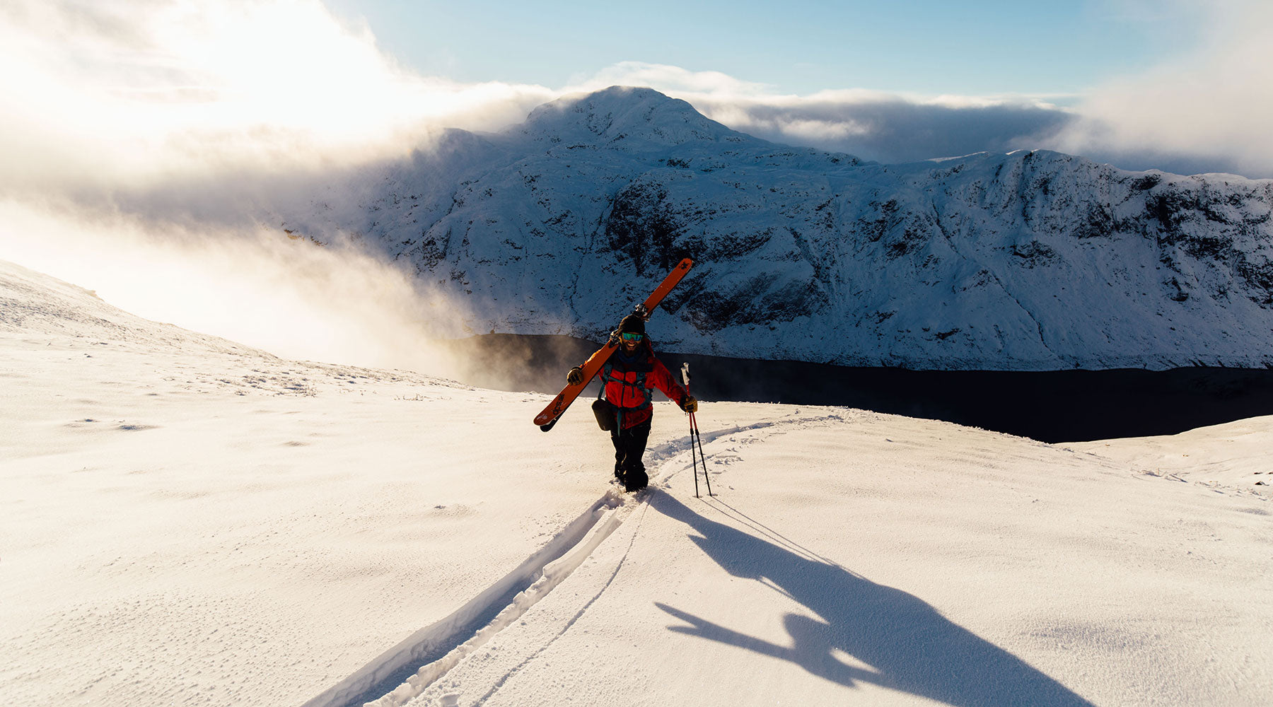 A man in red on a mountain skiing in Scotland