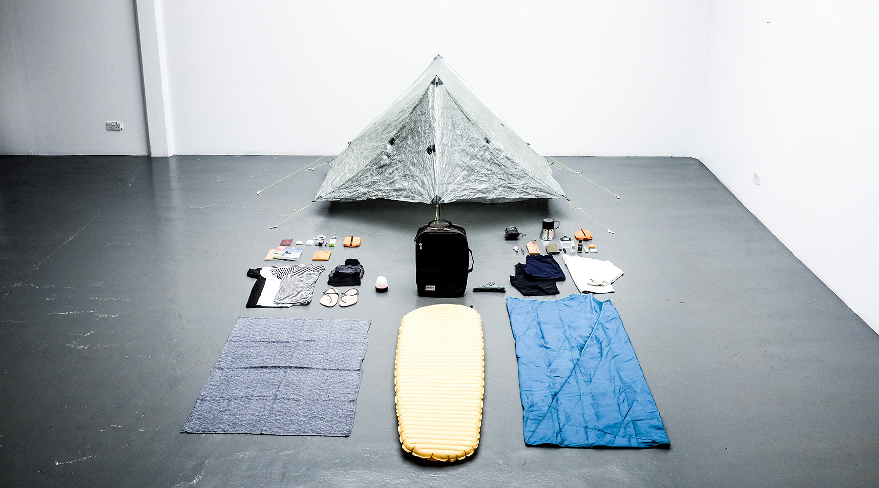 flatlay photo of a bag being packed using 4 classic packing hacks